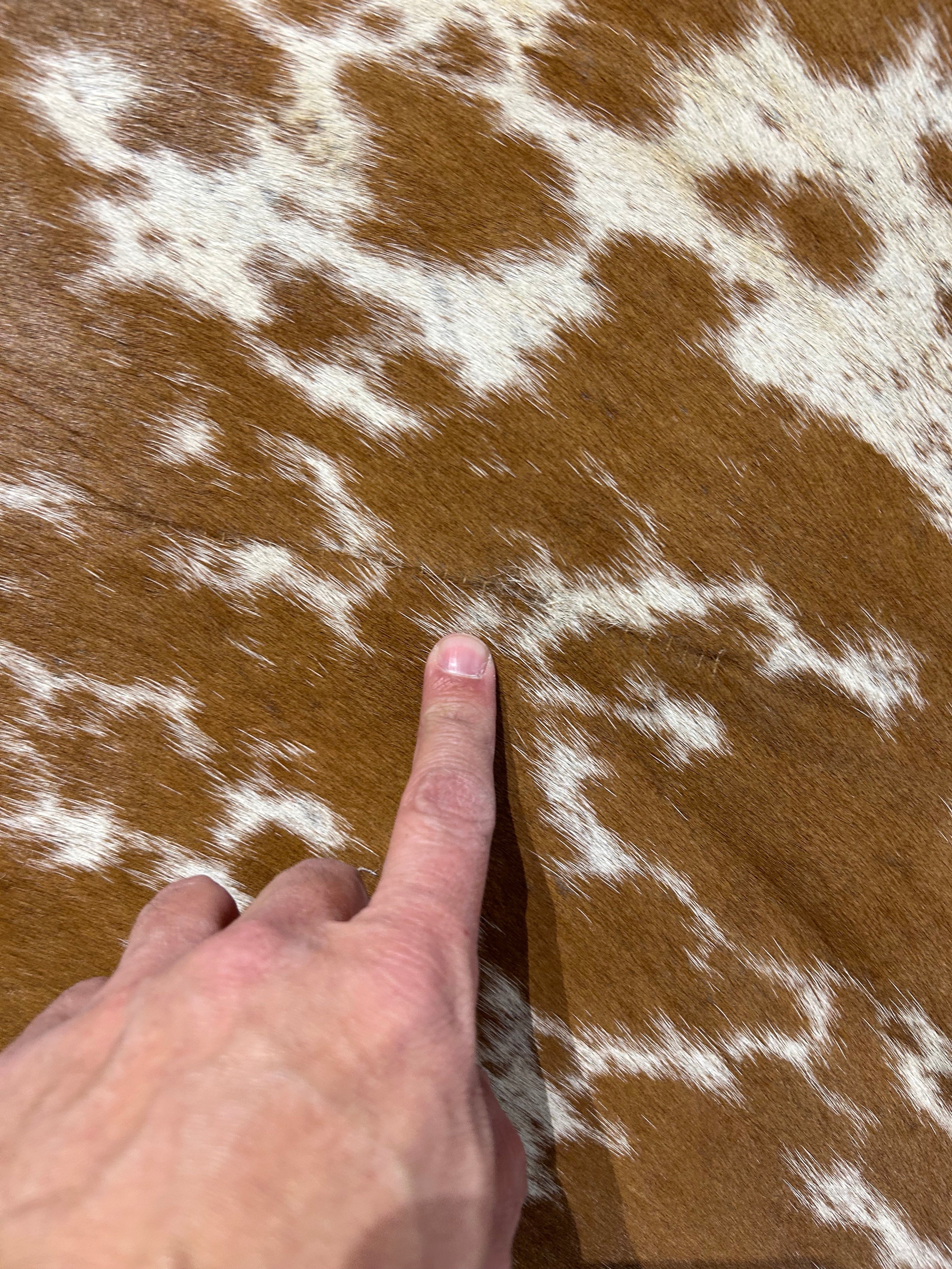 Spotted Brown & White Cowhide Rug (patch and hard to see stitches) Size: 6.2x6.2 feet D-047