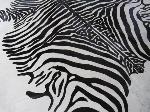 Zebra Print Cowhide Rug (light background but a few specs) Size: 7 1/4x6 3/4 feet C-1584