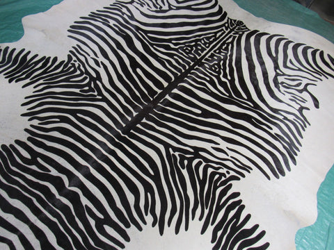 Zebra Print Cowhide Rug (light background but a few specs) Size: 7 1/4x6 3/4 feet C-1584