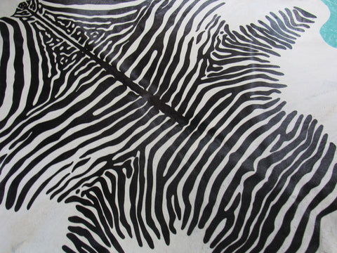 Zebra Print Cowhide Rug (light background but a few specs) Size: 7 1/4x6 3/4 feet C-1584